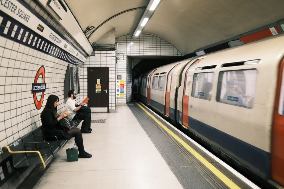 Inside the Stockwell tube station area, the image depicts a clean and well-maintained underground platform with polished tiles on the floor, featuring a combination of textured tactile paving and smoo